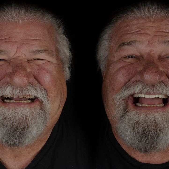 Two smiling older men with white beards against a black background.