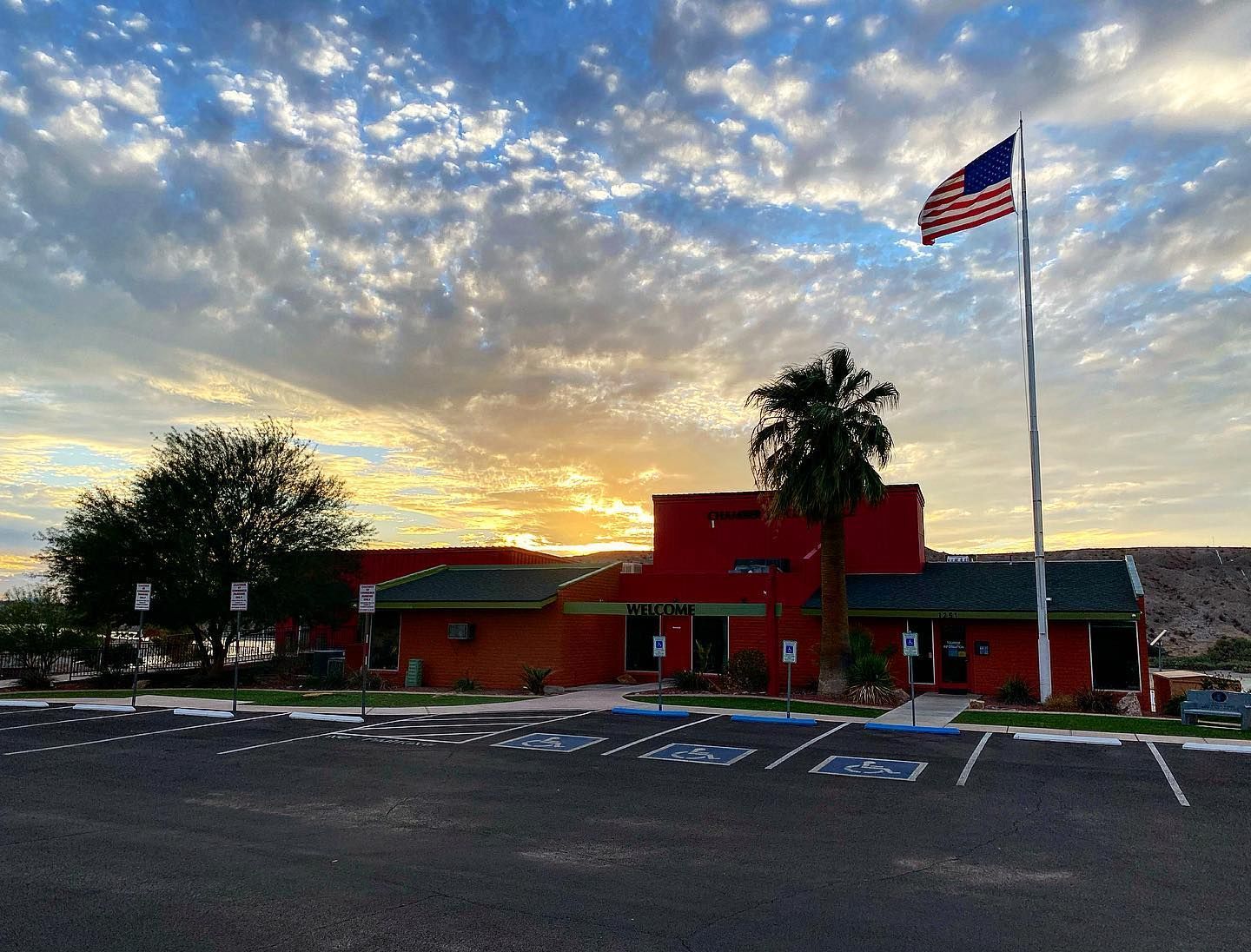 A large red building with a flag flying in front of it.