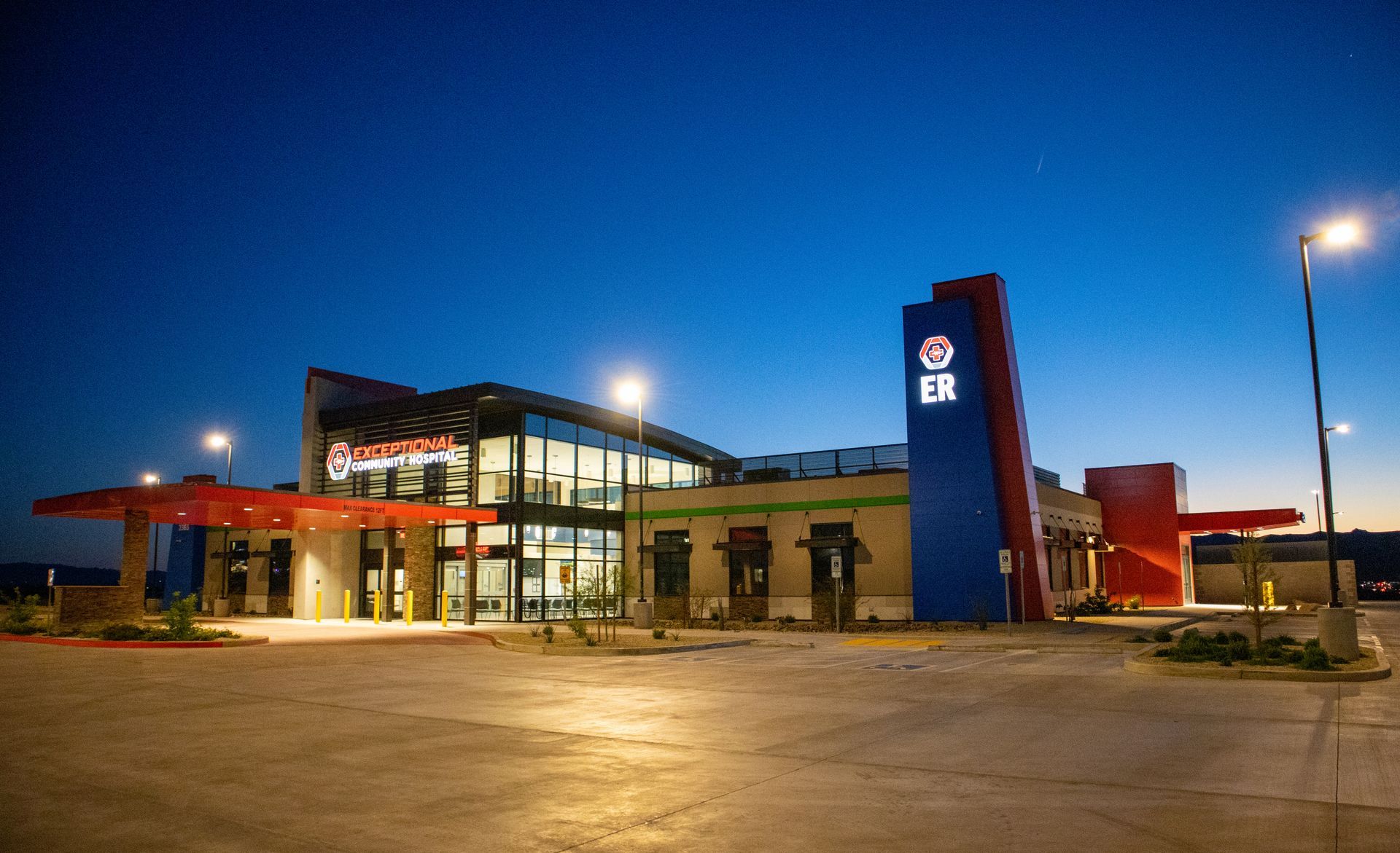 A large building with a lot of windows is lit up at night.