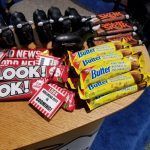 A bunch of candy bars are sitting on top of a wooden table.