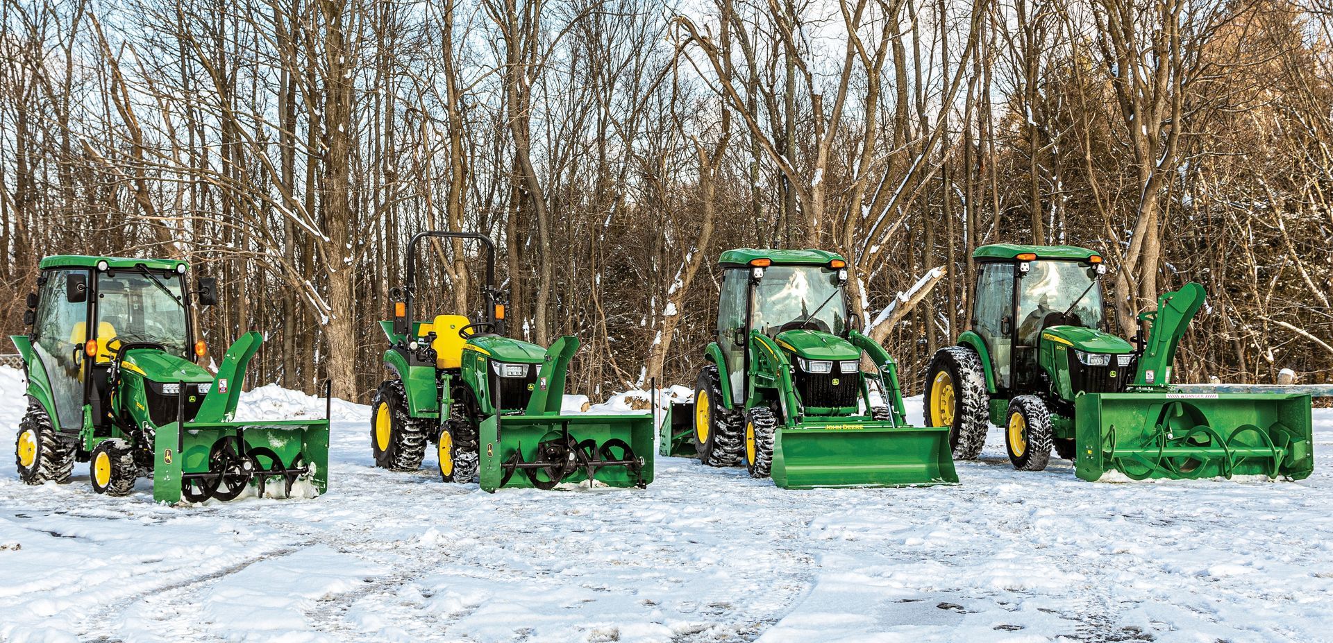A woman is riding a john deere lawn mower on a lush green lawn.