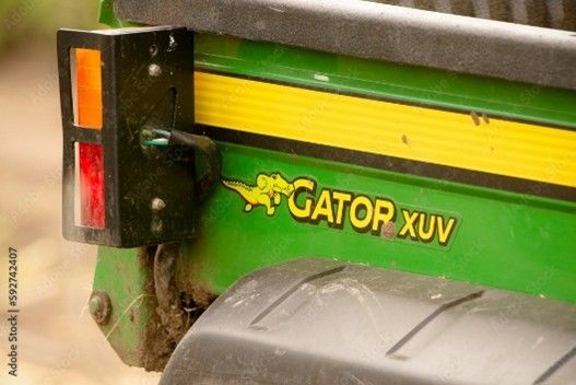 Gators utility vehicles rear view of green John Deere Gator XUV cargo bed and taillight close-up.