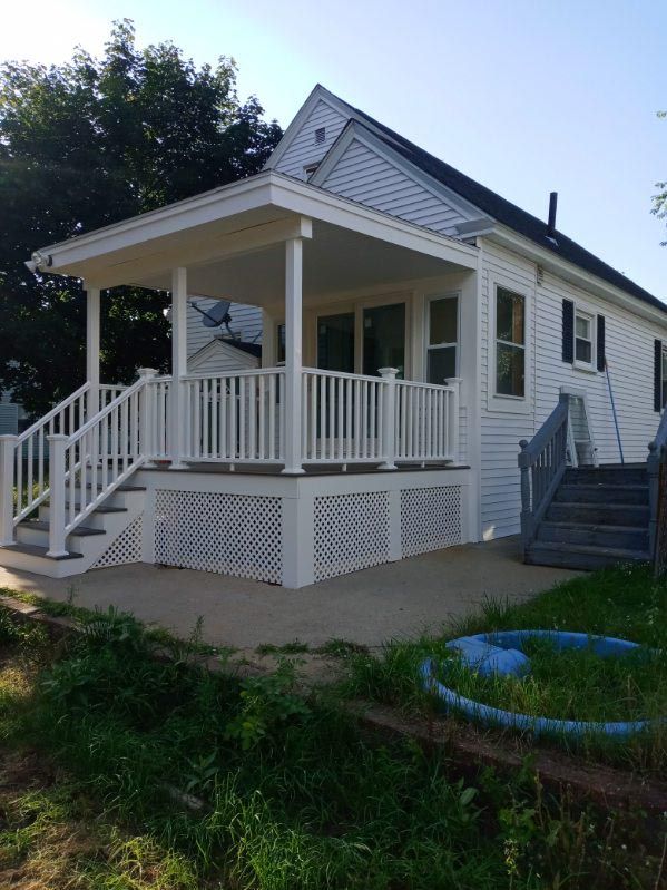 A white house with a porch and stairs