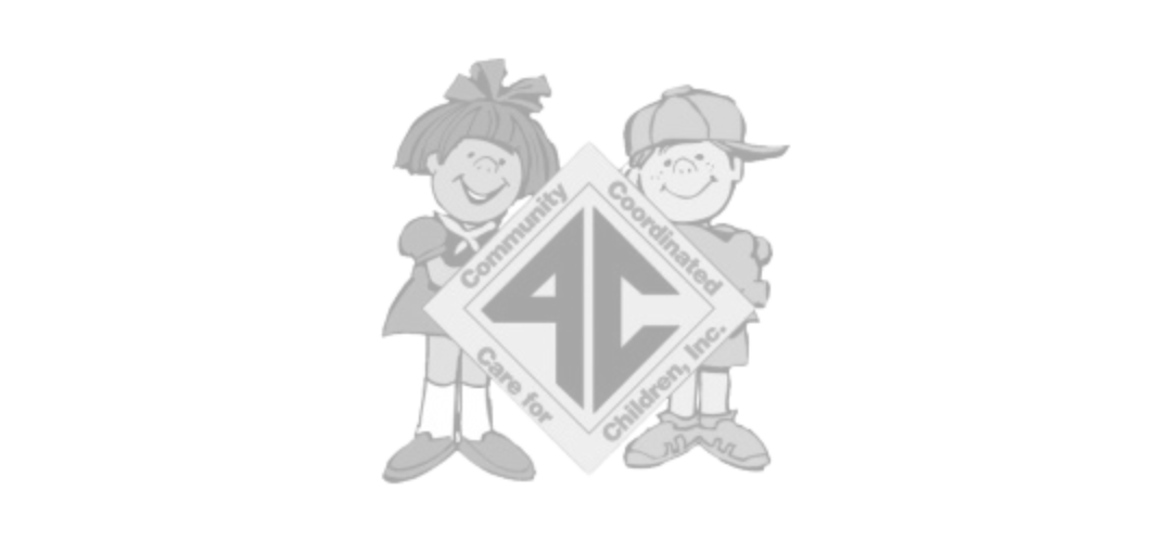 A boy and a girl are standing next to each other in front of a logo.