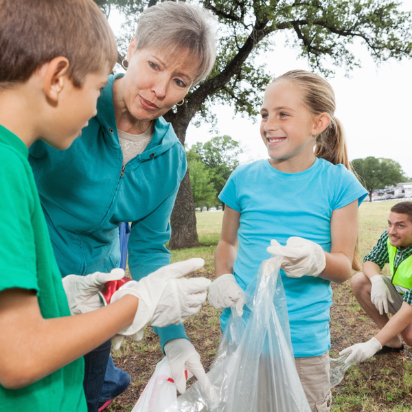 A group of people are picking up trash in a park