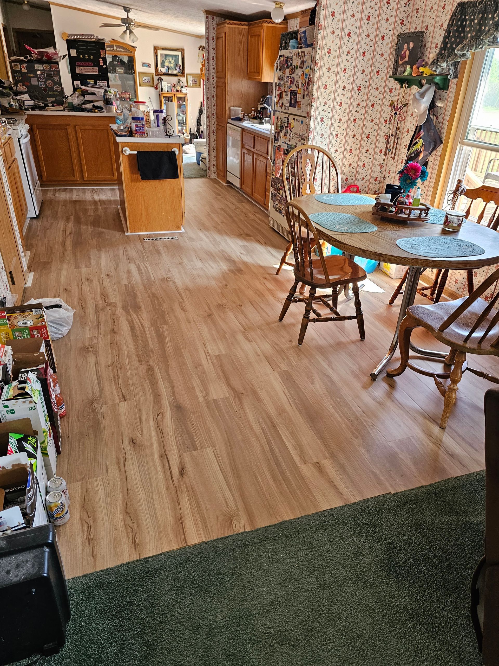 There is a table and chairs in the middle of the room.