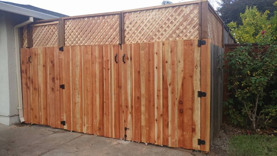 A wooden fence is sitting in front of a house.