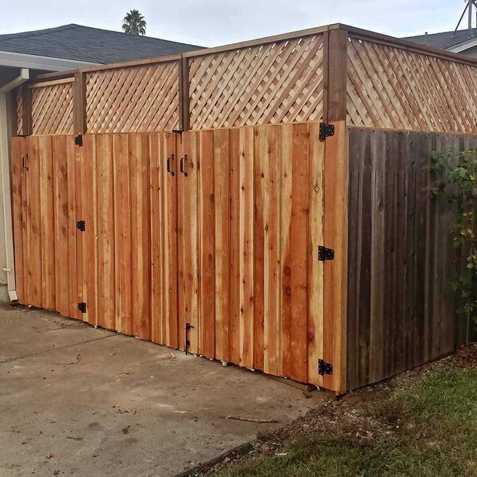 A wooden fence is sitting in front of a house.