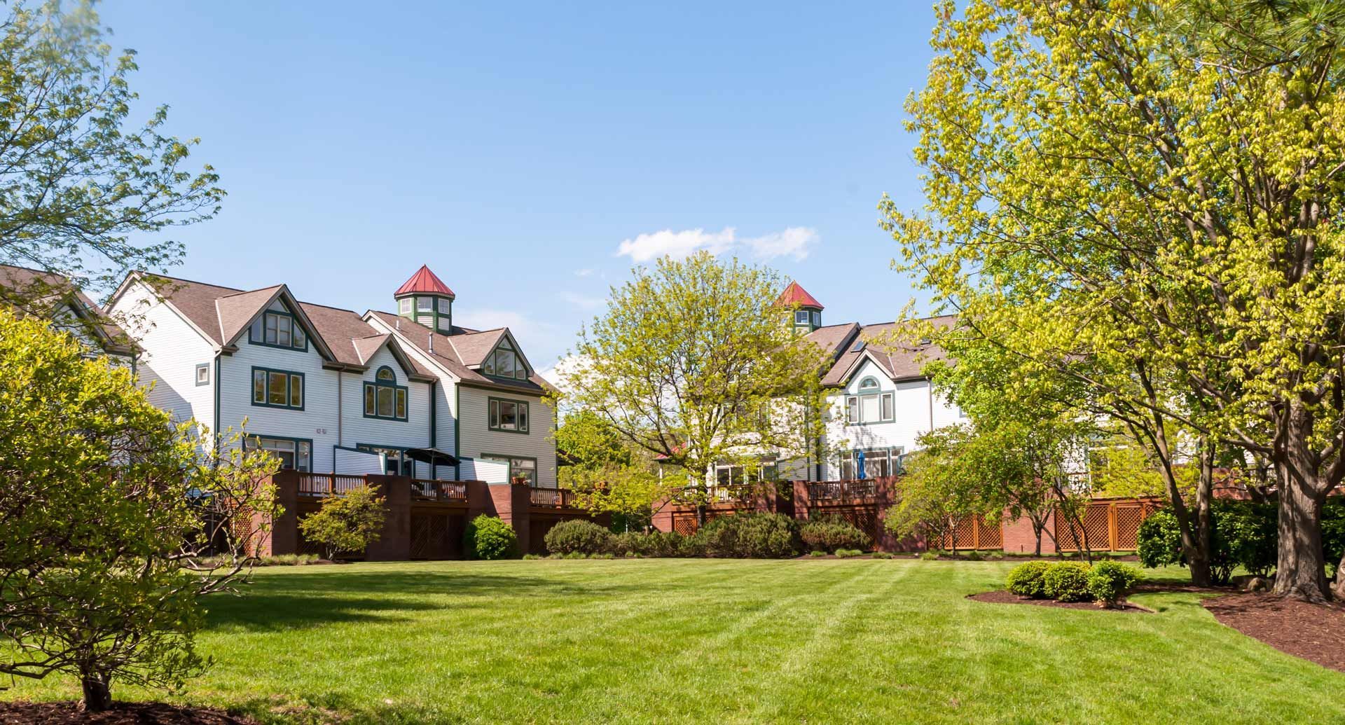 A row of houses with a large lawn in front of them