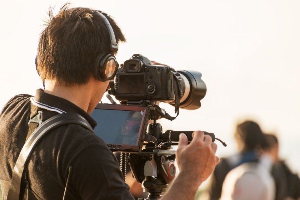 man recording with a camera