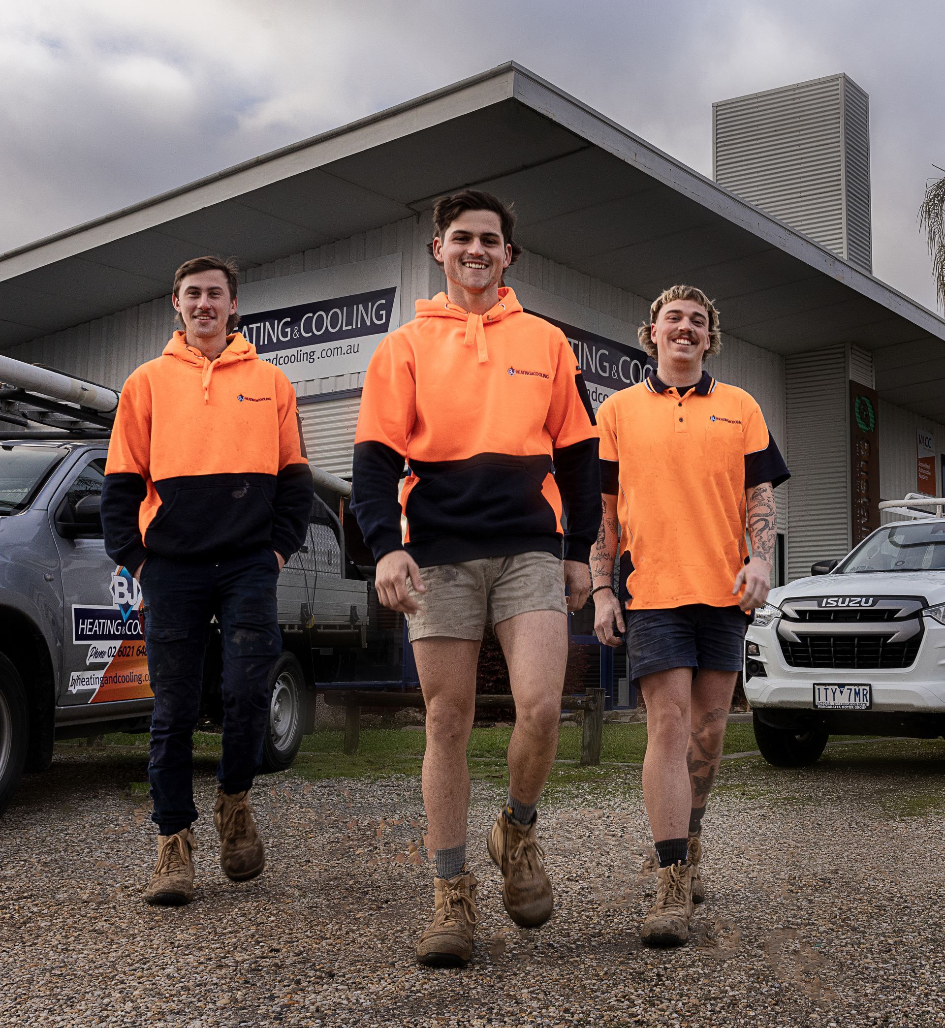 Three men are walking forwards and smiling — BJ Heating & Cooling in South Albury, NSW