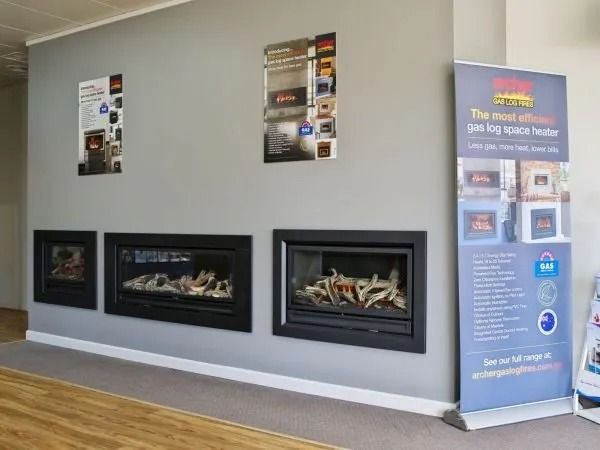 A Living Room With a Fireplace and a Sign on the Wall — BJ Heating & Cooling in South Albury, NSW