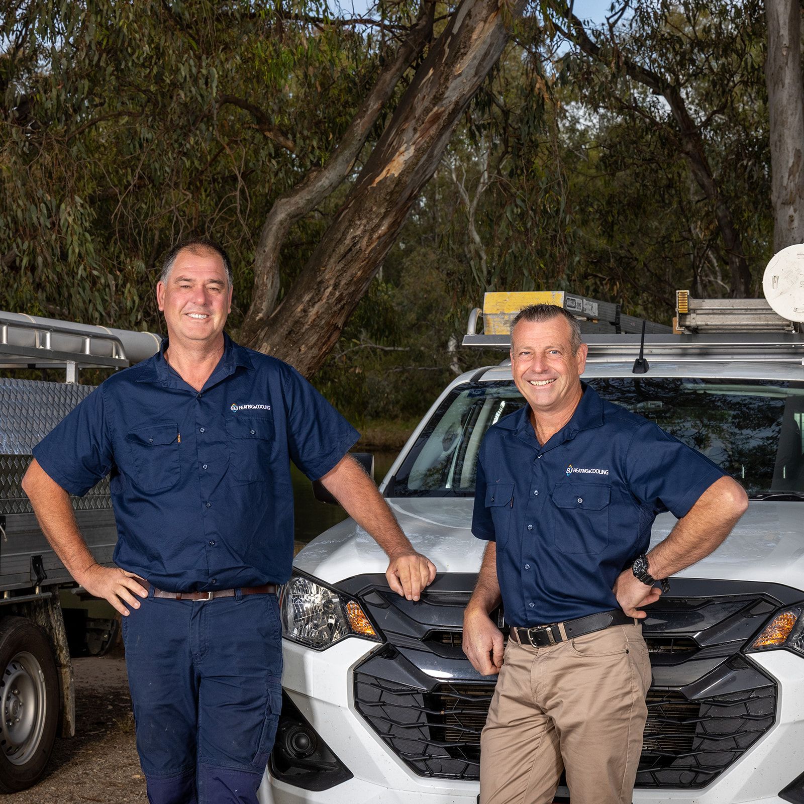 Three men are walking forwards and smiling — BJ Heating & Cooling in South Albury, NSW