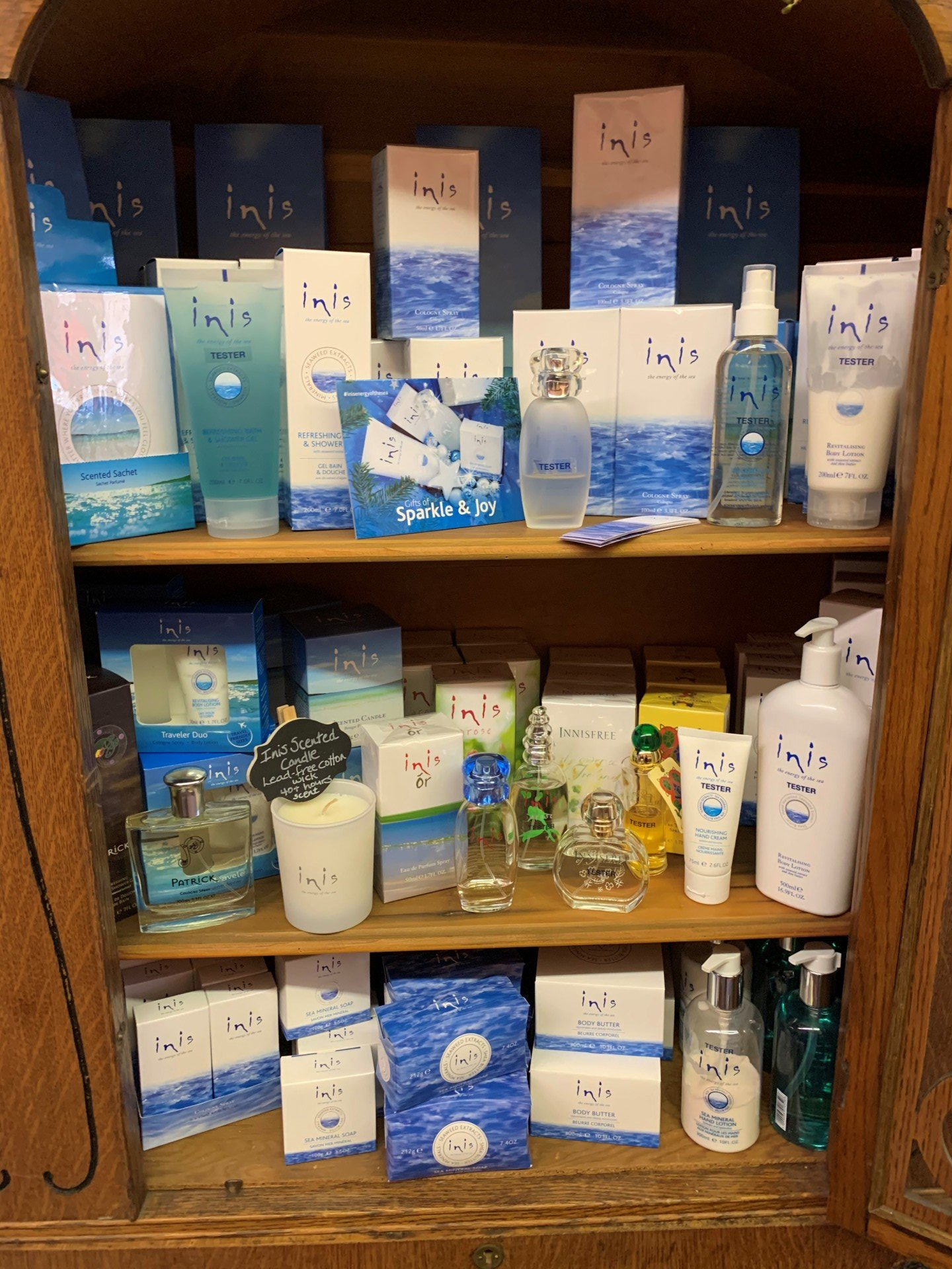 a shelf filled with a variety of cosmetics including perfume and lotion