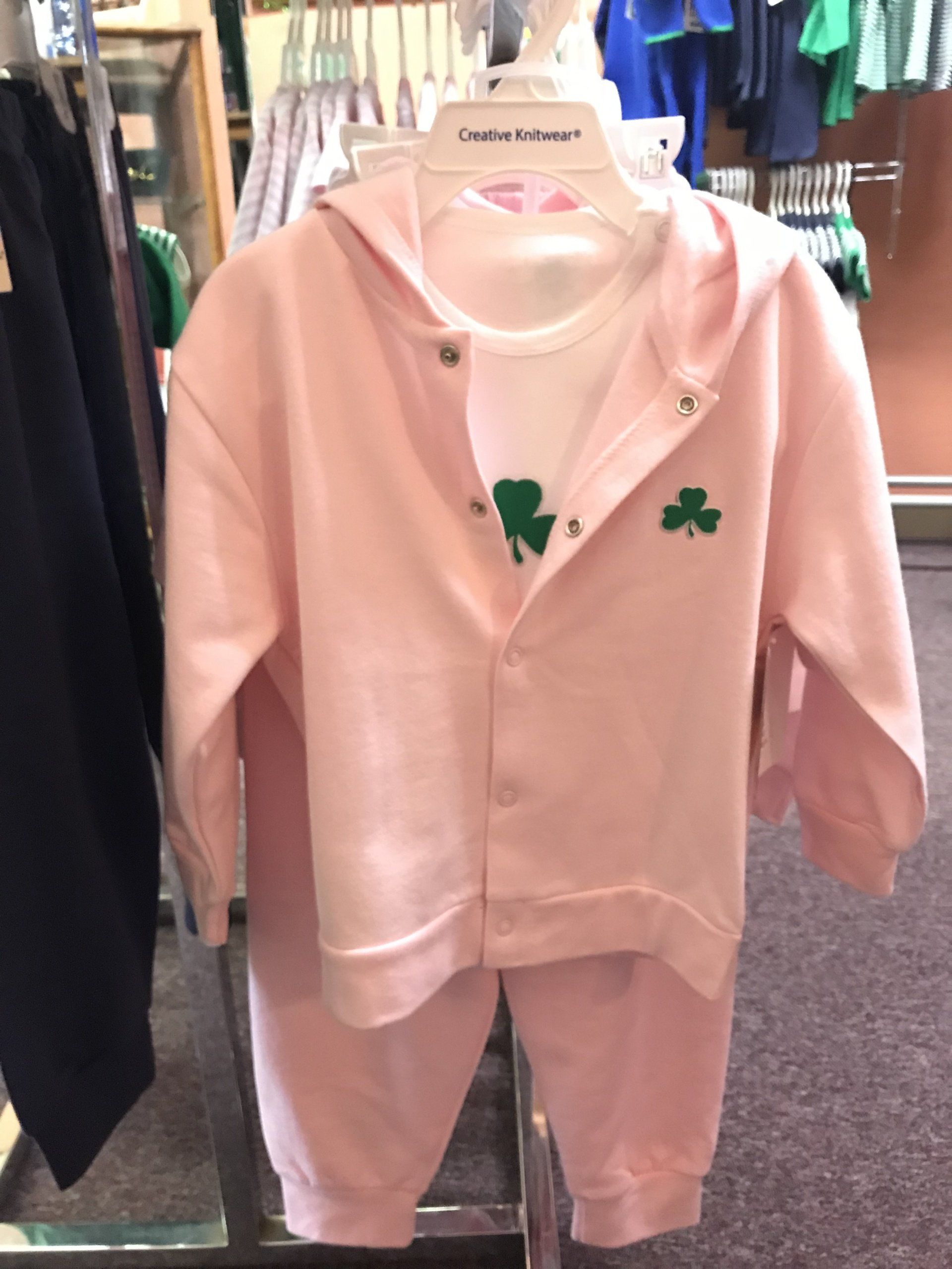 a pink hoodie with a green shamrock on it