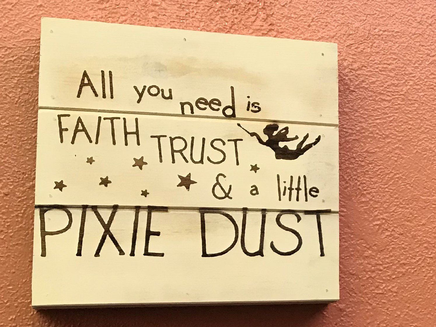 a sign that says all you need is faith trust and a little pixie dust