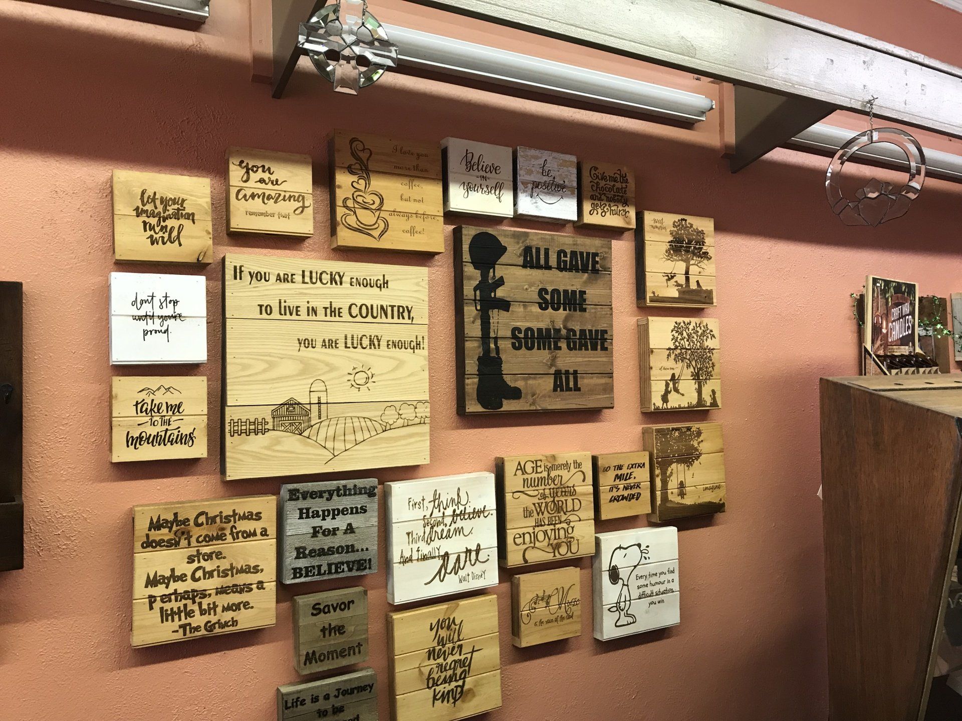 a wall with a lot of wooden signs on it