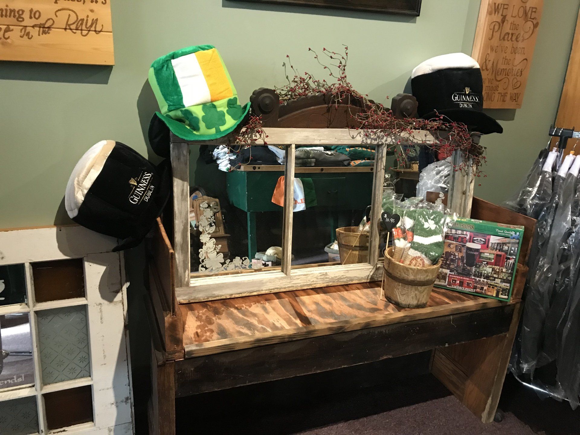 a wooden table with a mirror and hats on it