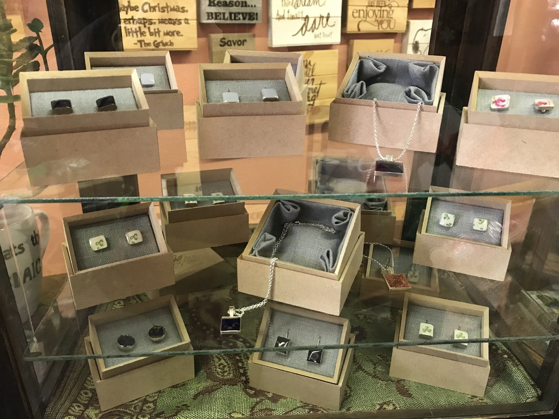 a display case filled with a variety of cufflinks and earrings .
