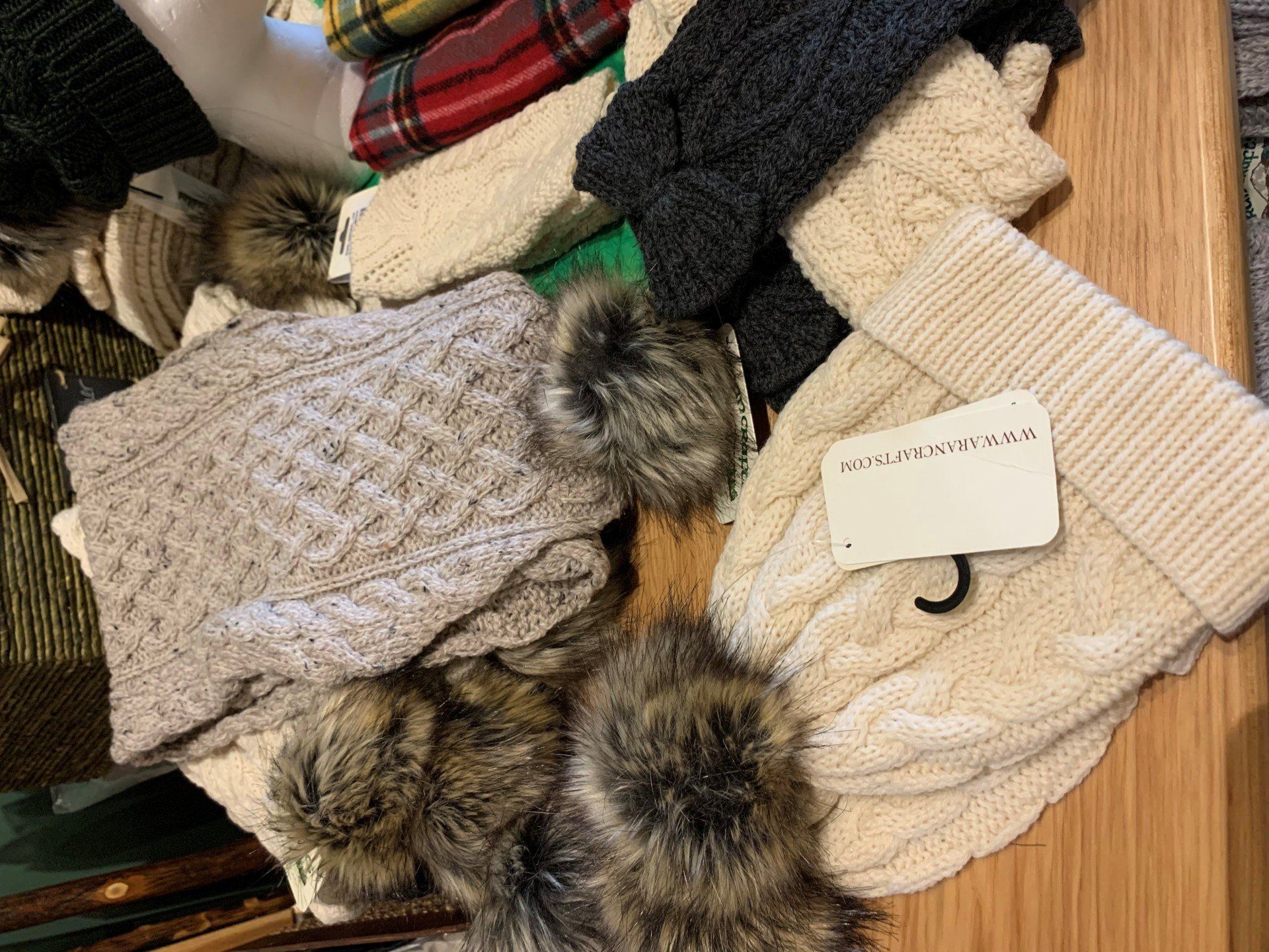 a bunch of hats and gloves are sitting on a wooden table .