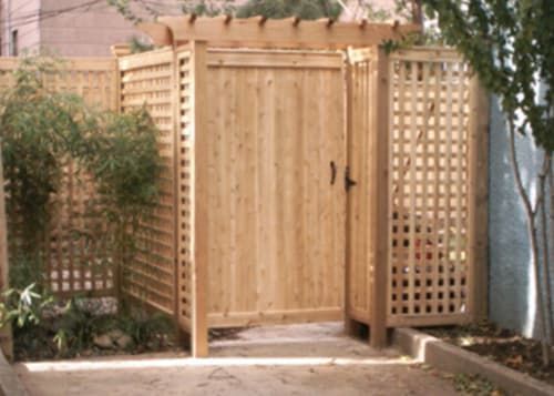 A wooden gate with a lattice fence around it