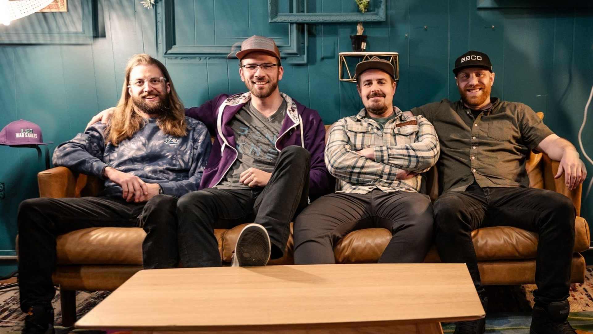 A group of men are playing guitars and singing into microphones on a stage.
