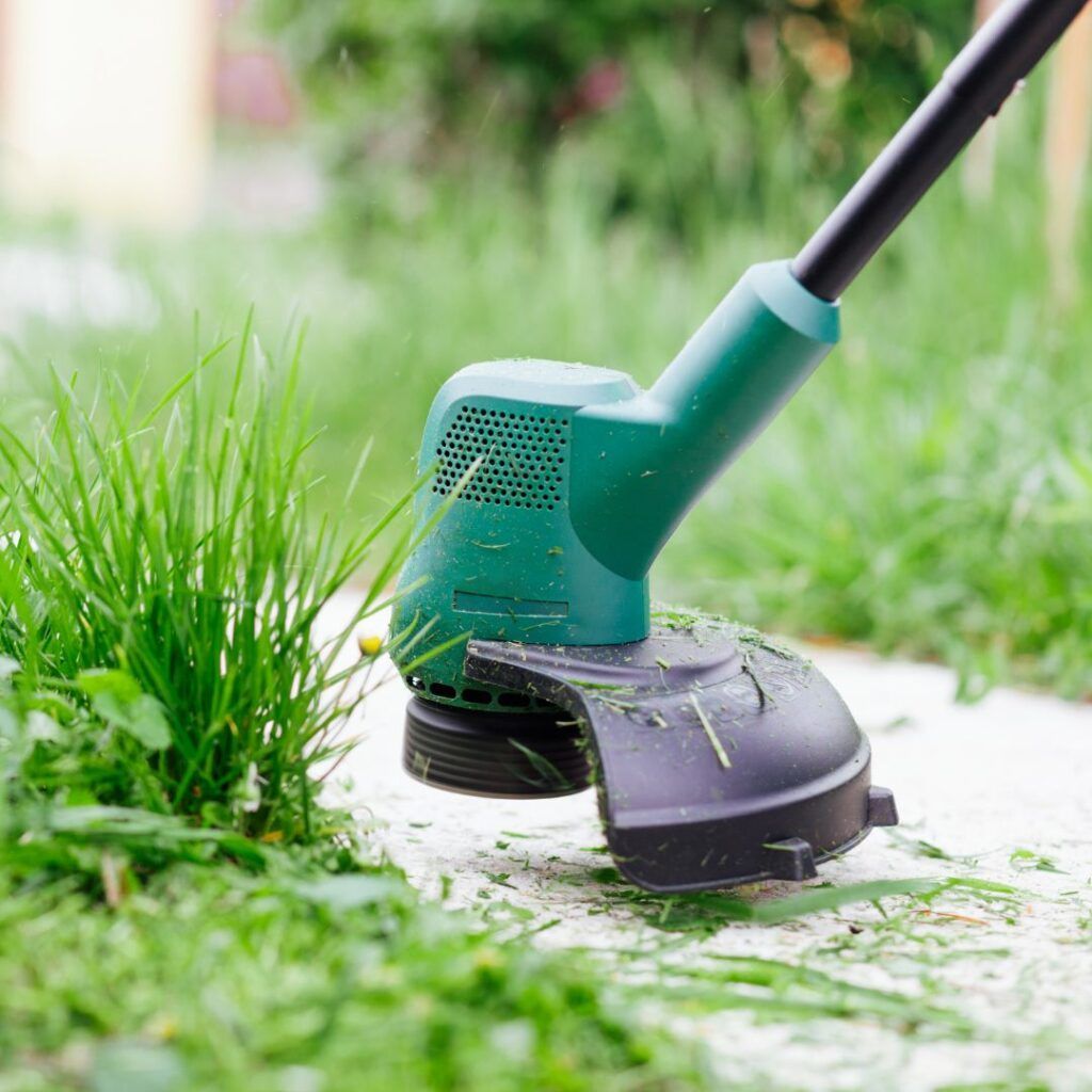 A person is using a lawn mower to cut the grass.