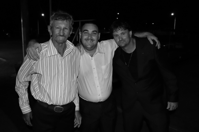 Three males smiling at the camera 