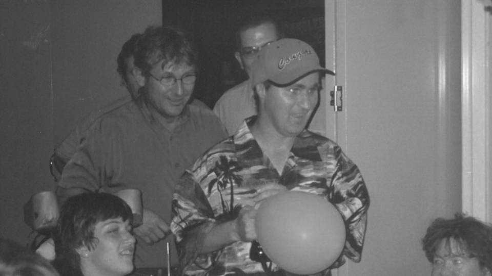 Clients at a party. One male holding a balloon
