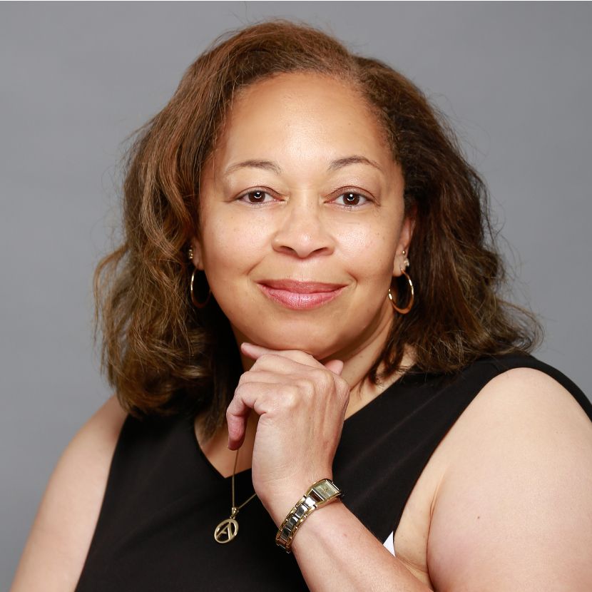 Two women are sitting at a table having a conversation.