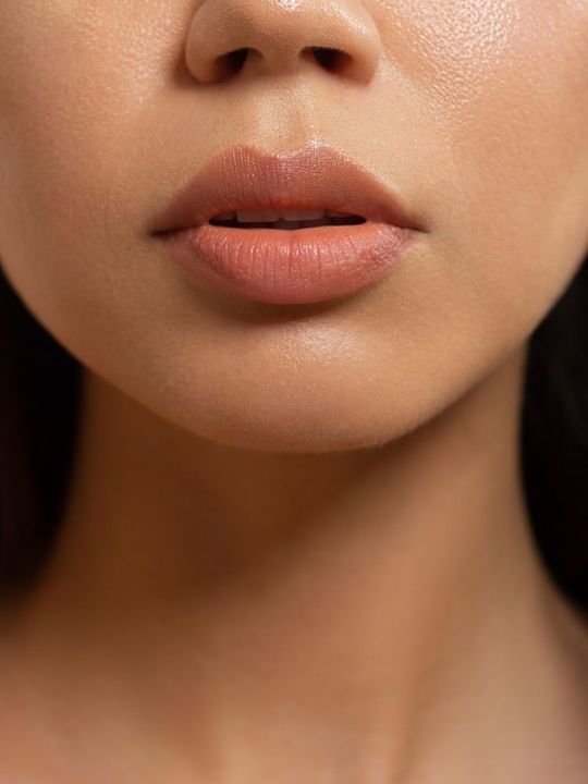 A close up of a woman 's face with her mouth open.