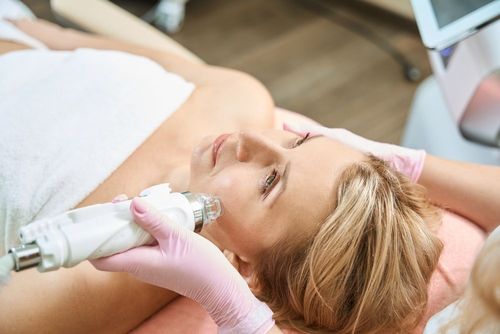 A woman is getting a facial treatment in a beauty salon.