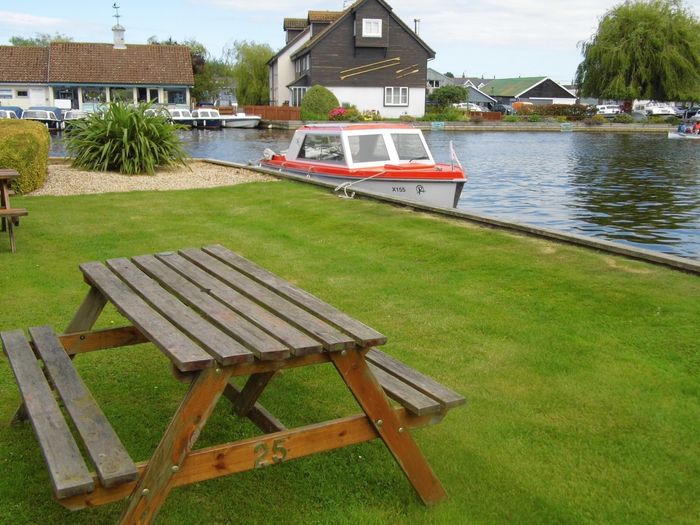 picnic table beside private mooring at Wherry cottage