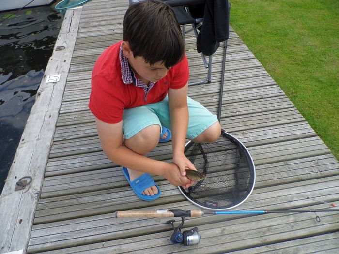 young boy just caught his first fish on mooring at Wherry cottage