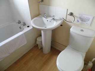 Bathroom, with full size bath, pedestal basin and w/c in Wherry cottage