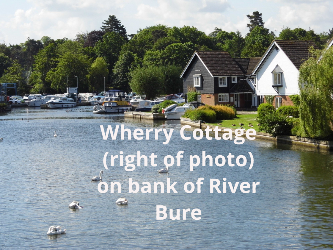 River Bure as seen from Wroxham Bridge. Wherry Cottage on right.