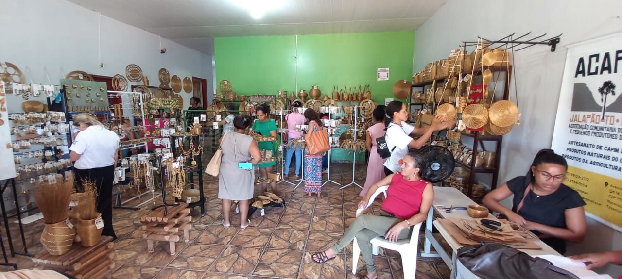 Um grupo de pessoas está de pé e sentadas em uma loja.