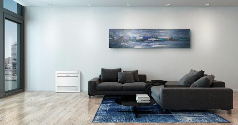 Modern living room with dark gray sofa, blue rug, painting, and white furniture.