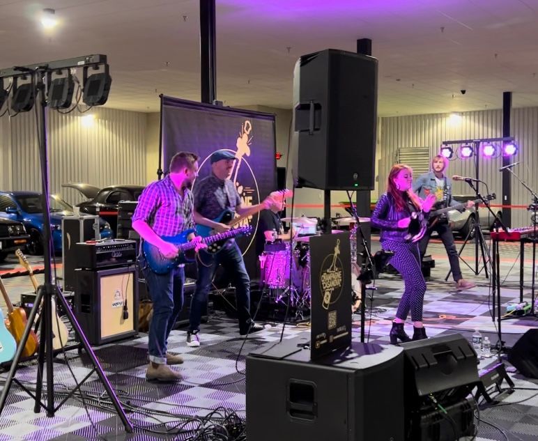 A group of people are playing instruments on a stage.