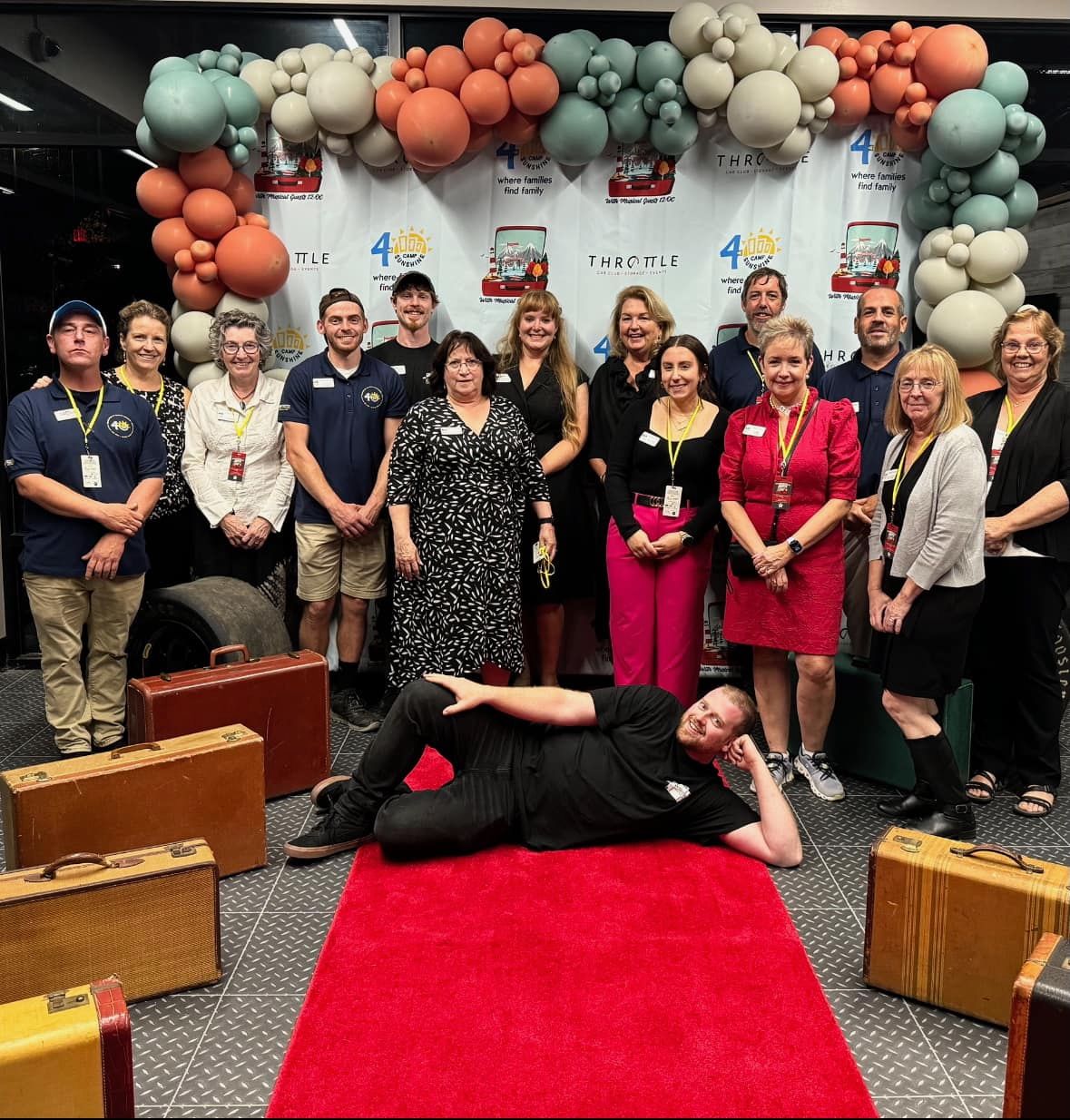 A group of people are posing for a picture on a red carpet