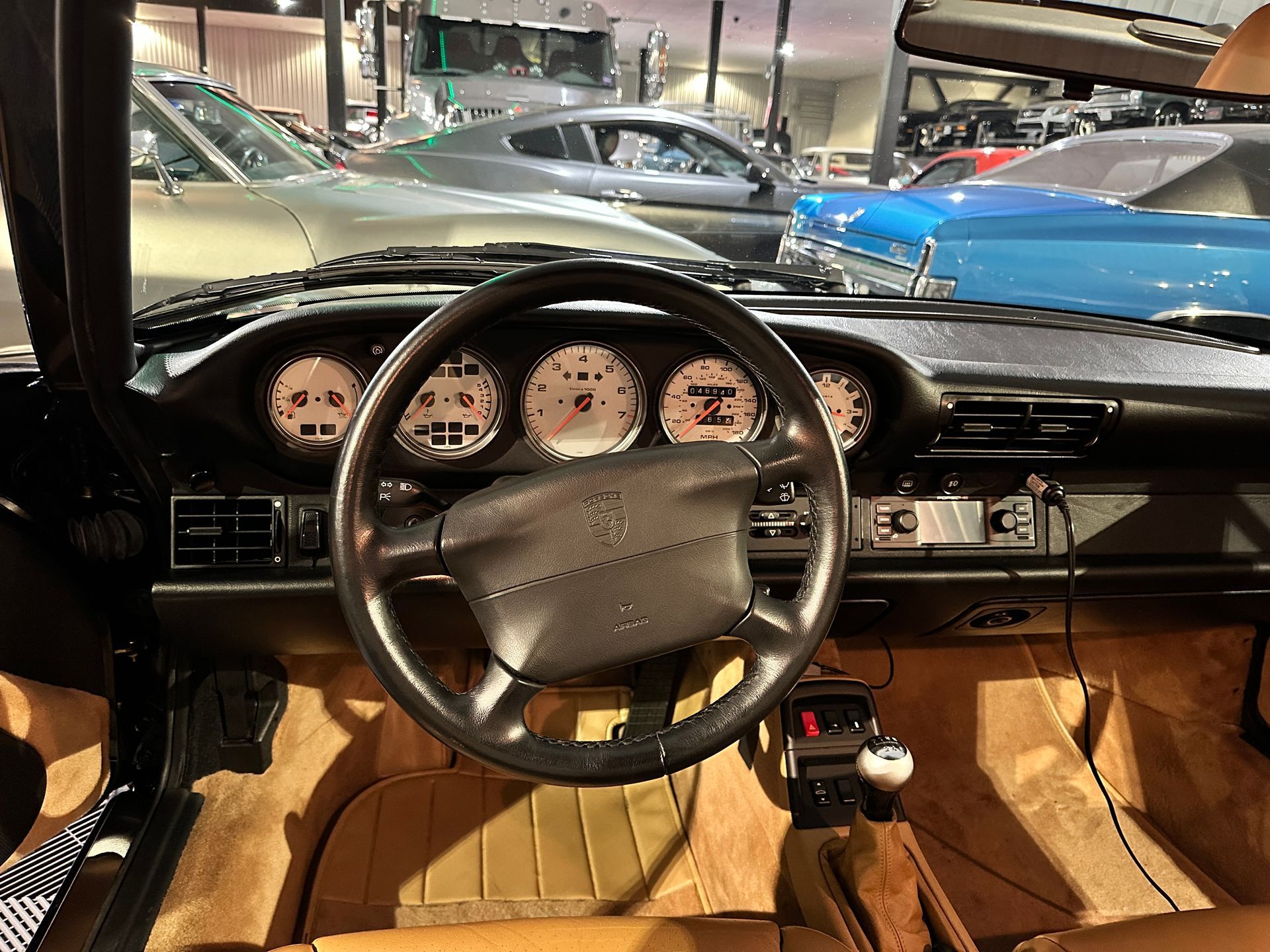 The inside of a car with a steering wheel and dashboard