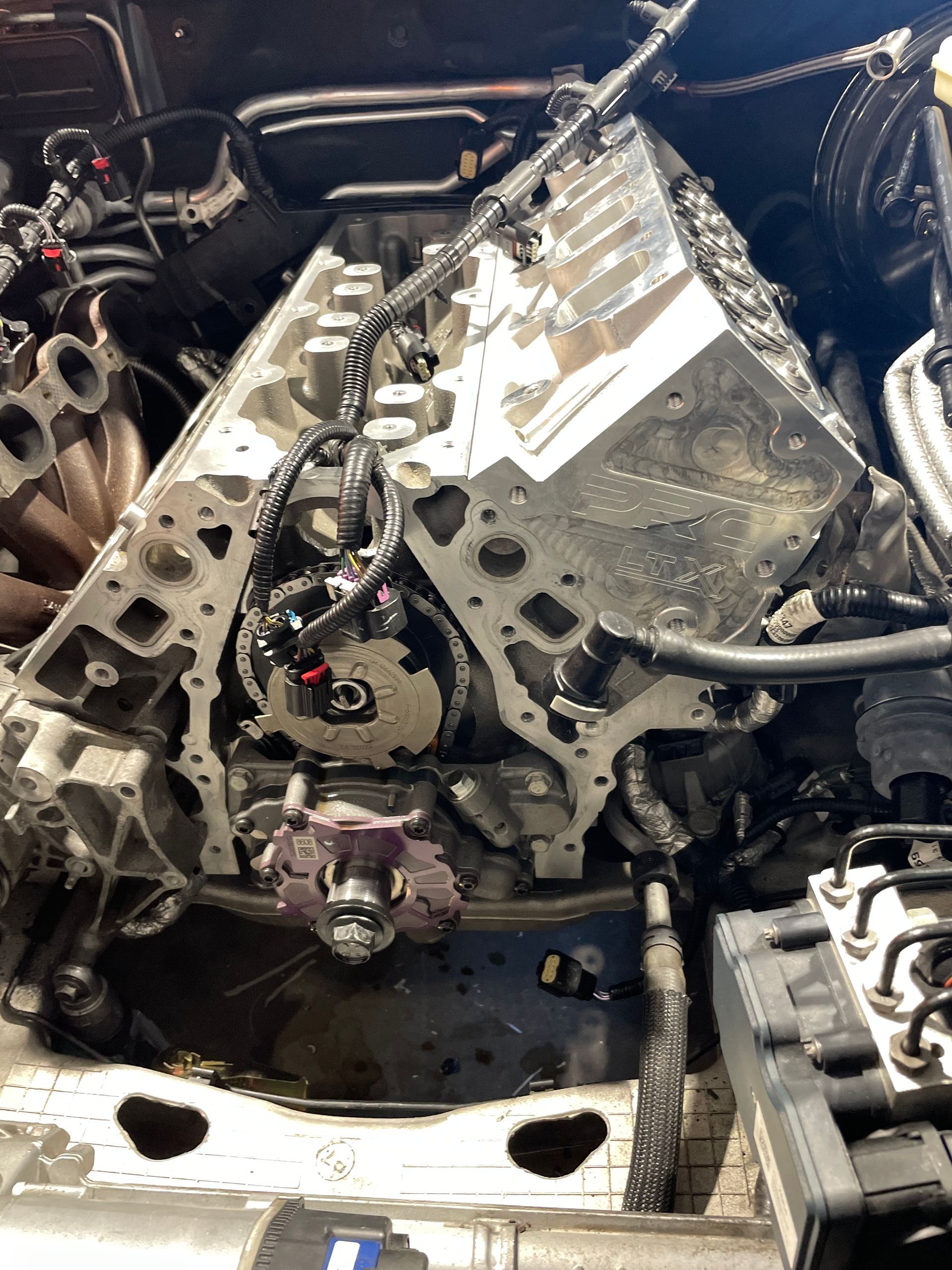 A close up of a car engine with the hood open.