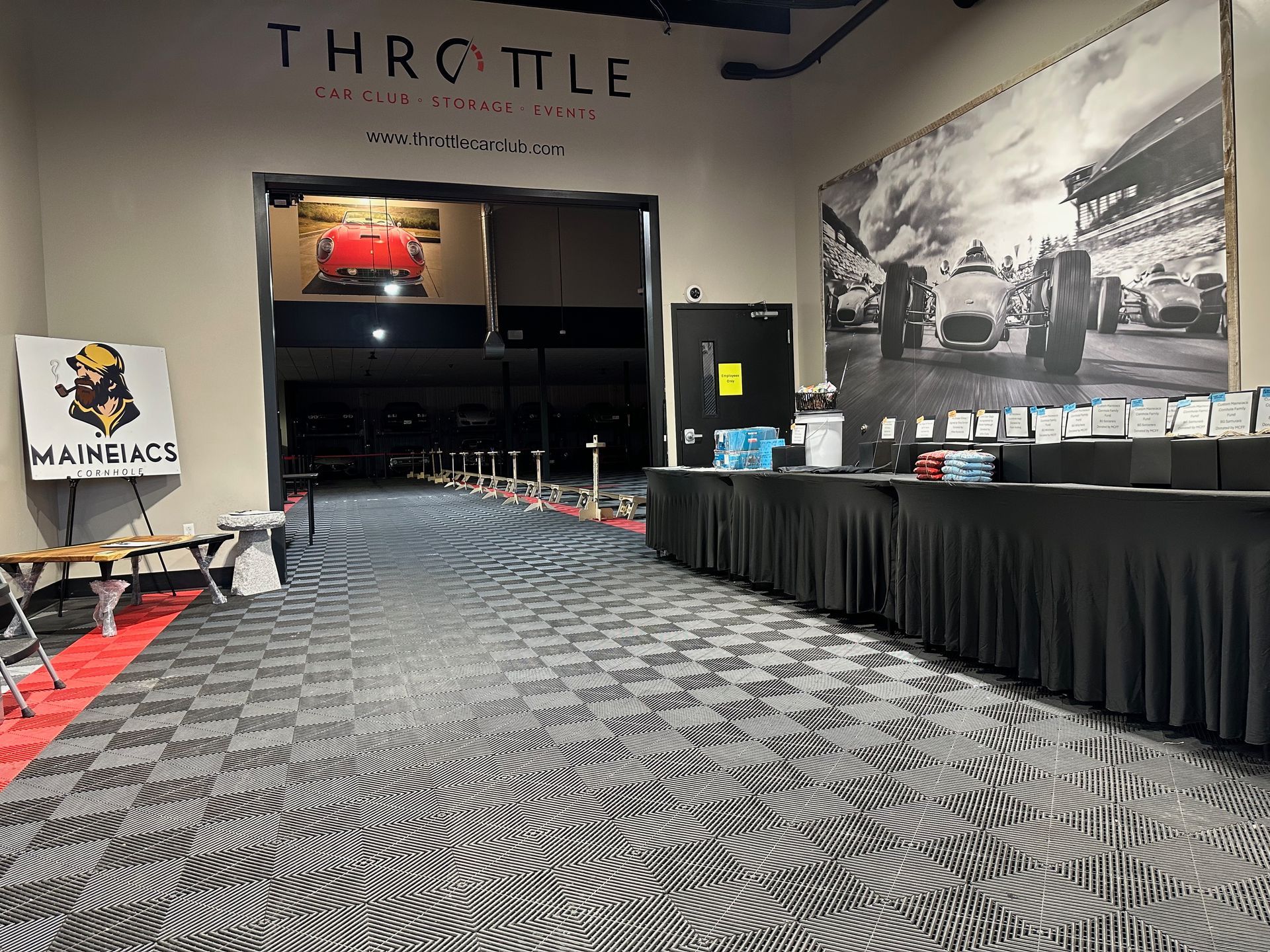 A room with tables and a sign that says throttle on the wall.