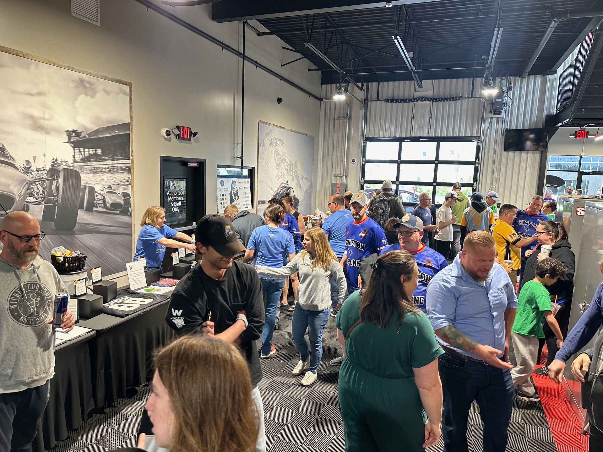 A large group of people are standing in a room.