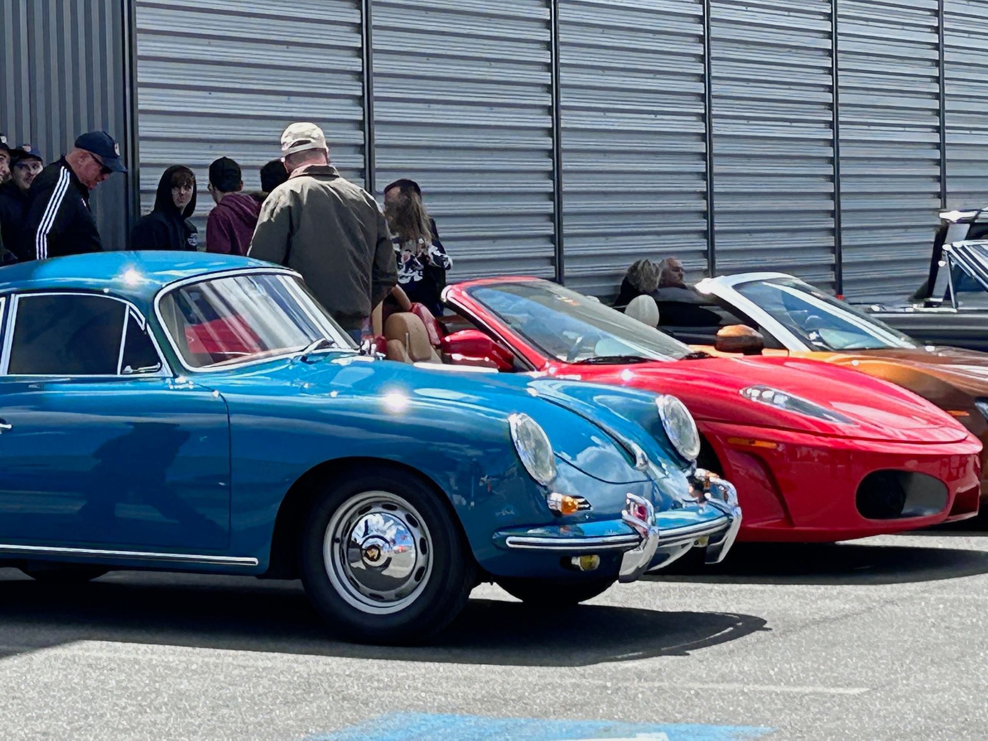 A group of cars are parked next to each other in a parking lot.