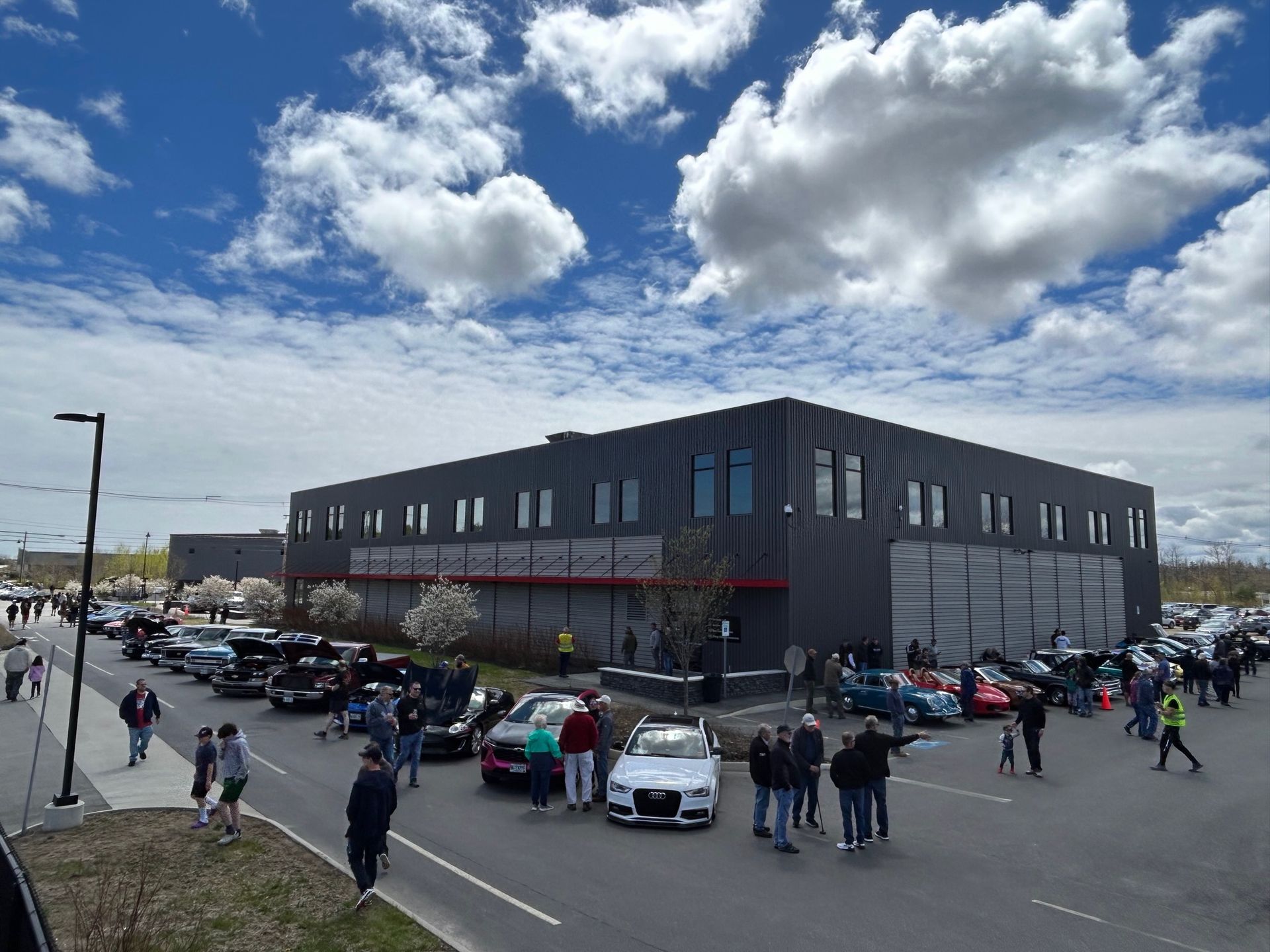 A large building with a lot of cars parked in front of it