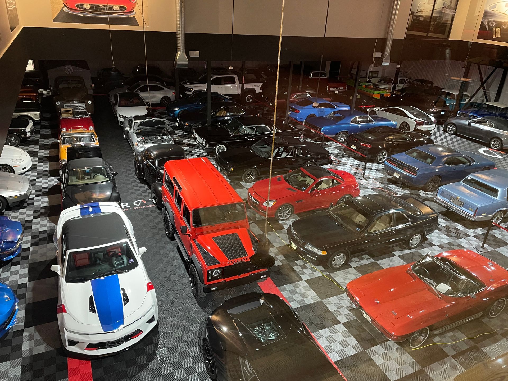 A lot of cars are parked in a garage.