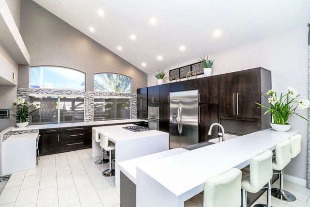 A large kitchen with stainless steel appliances and a large island.