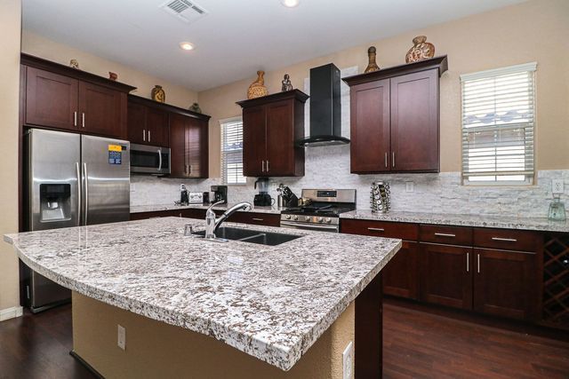 A kitchen with granite counter tops and stainless steel appliances