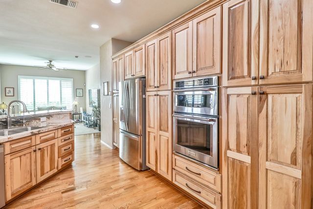 A kitchen with wooden cabinets and stainless steel appliances.